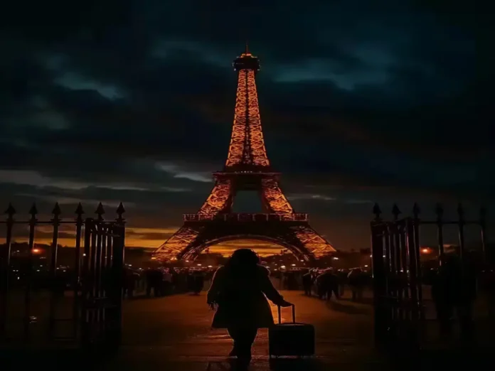 Eiffel Tower at dusk with partially closed gates and city lights