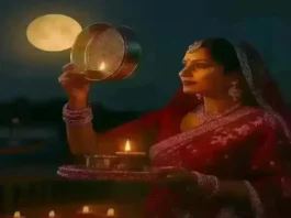 Indian woman performing Karwa Chauth 2025 rituals under moonlight with decorated thali